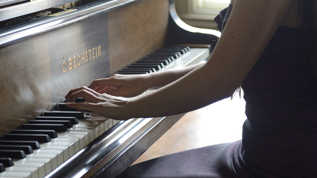 Close up of hands on a piano